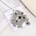 Detail shot of vintage flower basket brooch featuring sparkling silver and black rhinestones - Silver Black Tone Flower Basket Style