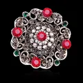 Vintage Baroque style brooch with red and green crystals on black background. - Silver