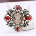 Close-up detail of a vintage court style cameo brooch with red and green rhinestones - Vintage Cameo (AL680071855347) / Colorful