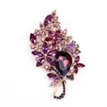 Elegant large floral brooch featuring purple crystals and teardrop gem in gold setting - Purple