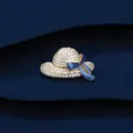 Exquisite sun hat brooch detail featuring pave white crystals and a navy blue enamel bow - Gold Blue Ribbon Hat