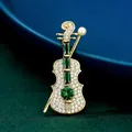 Elegant vintage violin brooch pin featuring green emerald stones and a pearl detail - Violin Brooch (AL736793235791) / Green
