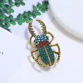 Detailed close-up of a vintage stag beetle brooch with vibrant blue and green crystals. - Stag Beetle Design