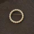 Close-up of elegant circular gold-toned brooch featuring multiple round pearl inlays - Round Full Pearl Encircled Style
