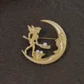 Detailed view of a vintage gold baroque moon and angel brooch with white pearls. - Crescent Moon and Angel Cupid Style