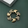Detail shot of vintage baroque style gold ginkgo leaf brooch with sparkling rhinestones - Micro Pave Rhinestone Ginkgo Leaf Ring Style