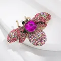 Vintage bijenbroche met roze kristal en strass vleugels in goudkleur - Bij Stijl 23