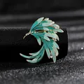 Macro detail view of elegant teal enamel wing brooch with sparkling rhinestones - Gradient Blue-Green Wing Style