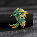 Close-up detail of a vintage elegant green and yellow wing brooch with rhinestones. - Yellow-Green Gradient Feather Style