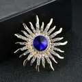 Elegant sunburst crystal brooch with large blue center stone and gold-toned finish - Dark Blue Gold Ray Sunburst Brooch