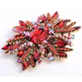 Elegant vintage red crystal and rhinestone sunburst brooch in gold-tone metal - Red Sunburst Style