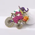 Detailed view of colorful witch riding bicycle brooch with rhinestones and enamel - Pink Rhinestone Witch / Pink