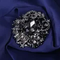 Detailed macro view of vintage crystal brooch with large grey gemstone on blue silk - Gray (S2)