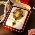 Detailed macro view of a vintage medieval style cameo brooch inside a red jewelry gift box - Lady Portrait Cameo (Champagne) / Champagne