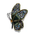 Close-up of an intricate butterfly brooch featuring colorful rhinestones and filigree. - Side-flying Large Butterfly / Green