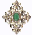 Close-up of vintage baroque brooch with green stone and sparkling rhinestones - V018