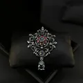 Vintage palace style brooch with blue and red rhinestones displayed in a jewelry box - Vintage Crown Style (01)