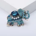 Detailed macro view of a vintage elephant brooch featuring blue rhinestones and gems - Blue