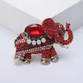 Detailed macro shot of a vintage elephant brooch featuring red rhinestones and alloy finish. - Red