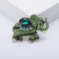 Macro view of a retro green rhinestone elephant brooch showcasing exquisite jewelry details. - Green