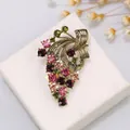 Vintage grape alloy brooch with multi-color crystals on white display - Vintage Multicolor Grape Cluster Style