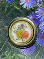 Detailed macro view of vintage gold-rimmed resin stud earring with real dried flowers - Round Style (AL706706020037)