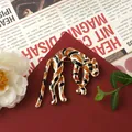 Detail of vintage baroque leopard brooch with orange and black enamel spots on gold. - Leopard Shape
