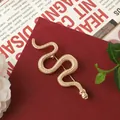 Close-up detail of vintage Baroque style gold snake brooch with textured scale pattern - Vintage Snake Shaped