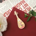 Detailed view of a vintage Pipa-shaped brooch with deer and lotus enamel design - Lute Shape