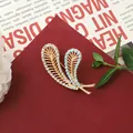 Vintage Baroque feather brooch with rhinestones and turquoise beads - Feather