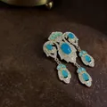 Raffinata spilla barocca vintage con pietre blu e ciondoli a forma di goccia dorata - Stile Ciondolo a Nappa Pietra Blu