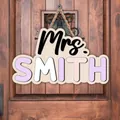 Personalized Mrs. Smith wooden teacher name sign hanging on a door as back to school gift - Purple White Pink Letters Natural Wood Board