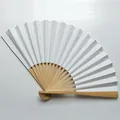 Detail of a 9-inch white blank folding fan showing natural bamboo ribs structure - White