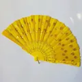 Macro detail of a bright yellow sequin folding fan with elegant gold embroidery and floral motifs - Yellow