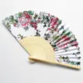 Macro detail of a traditional silk folding fan featuring elegant pink peony floral patterns. - Size 15