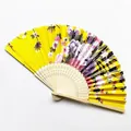 Traditional Japanese folding fan with vibrant yellow satin fabric and elegant floral print - Style 16 Bright Yellow