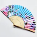 Close-up view of a blue floral fabric Japanese folding fan with natural bamboo ribs - Style 18 Light Blue