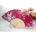 Traditional magenta floral silk folding fan with elegant bamboo ribs on wooden display stand - No.10 Wine Red