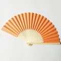 Close-up of a vibrant orange folding paper fan with detailed openwork carving ribs - No. 1 / Orange