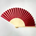 Detail view showing a deep red silk folding fan with intricate bamboo rib carvings. - Wine Red (No.6)