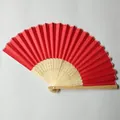 Close-up of a red silk folding fan with intricately carved bamboo ribs on plain background. - Red (No. 15)