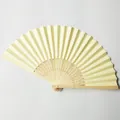 Close-up of beige paper wedding fan with carved bamboo ribs for DIY crafts. - Light Yellow