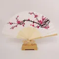 Close-up detail of a traditional silk folding fan featuring pink plum blossom art. - Folding Fan / Pink Plum Blossom (Plastic Fastener)