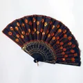 Detailed view of a Spanish-style folding fan with orange sequins and peacock tail pattern. - 23CM*42CM / Black Ribs Orange Sequin