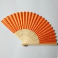 Close-up detail of a bright orange silk folding fan with hollowed bamboo frame ribs - Orange (No.20)