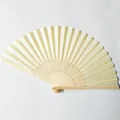 Close-up view of a traditional white silk folding fan featuring hollow-carved bamboo ribs - Light Yellow (No.22)