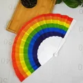 Overhead view of vibrant rainbow folding fan displayed on a grid measurement surface - 23cm / Plastic Rib Round Edge