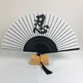 Detail of Chinese 6-inch folding fan featuring 'Endure' calligraphy and black tassel - Patience Calligraphy Style