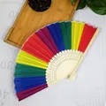 Detail of a rainbow folding fan with colorful fabric and decorative ribs. - 21cm / Bamboo Rib Vertical Stripes
