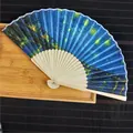Close-up detail of a traditional bamboo folding fan featuring The Starry Night painting - Starry Sky / 21cm